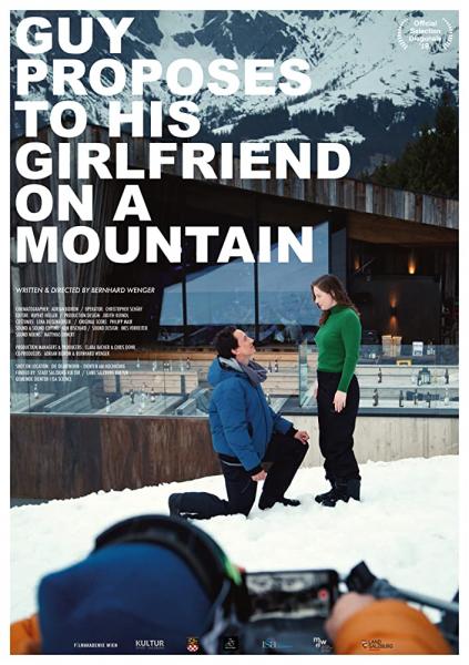 Guy proposes to his girlfriend on a mountain logo
